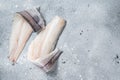 Two raw haddock fish fillets on kitchen table. Gray background. Top view. Copy space Royalty Free Stock Photo