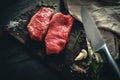 Two raw meat steak on a wooden Board on a table Royalty Free Stock Photo