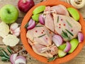 Two raw organic chicken with green apples, red onion and rosemary Royalty Free Stock Photo