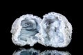 Two raw quartz druse or geode mineral stone in front of black background