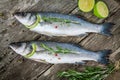 Two raw seabass with lime and rosemary Royalty Free Stock Photo