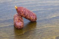 Two raw smoked sausages on a wooden brown board Royalty Free Stock Photo