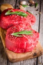 Two raw steaks with rosemary, garlic, salt and pepper