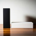 Two rectangular boxes one black and one white are placed on a wooden surface isolated on white background Royalty Free Stock Photo