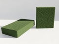 Two rectangular green foam blocks placed on a white surface Royalty Free Stock Photo