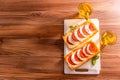 Two rectangular mini pizzas with tomatoes and mozzarella and homemade lemonade on a wooden table. View from above Royalty Free Stock Photo