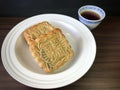 Two Red bean moon cakes served with tea on wooden background . Royalty Free Stock Photo