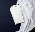 Two rectangular white cutting kitchen boards on a blue wooden background, next to a white textile towel, top view Royalty Free Stock Photo