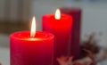 Two red advent candles are buring brightly on a modern advent wreath.