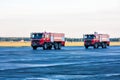 Two red airfield fire trucks at the airport
