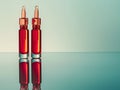Two Red Ampoules on Reflective Surface Royalty Free Stock Photo
