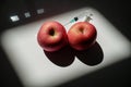 Two red apples that can symbolize two full breasts or two muscular testicles in which is planted a syringe Royalty Free Stock Photo