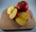 Two red apples on a chopping board Royalty Free Stock Photo