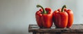 Two Red Bell Peppers with Water Drops on Rustic Wood Royalty Free Stock Photo