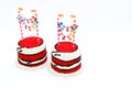 Two red birthday cakes with banners