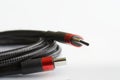 Two red-black usb type-c connectors and a black reinforced braided wire on a light background. Modern way to connect, transfer