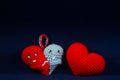 Two red and blue handmade plush hearts that hug each other for love on Valentines Day Royalty Free Stock Photo