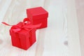 Two red boxes on a wooden table, selective focus. gift, packaging