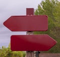 Two red burgundy signs without text pointing opposite directions Royalty Free Stock Photo