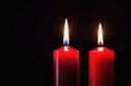 Two red candles burns on a dark background. Memory, memorial, romance, prayer, religion. Copyspace, free space, place Royalty Free Stock Photo