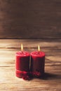 Two red candles tied with red ribbon, the symbol of Valentine`s day, mimics the relationship of men and women Royalty Free Stock Photo