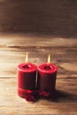 Two red candles tied with red ribbon, the symbol of Valentine`s day, mimics the relationship of men and women Royalty Free Stock Photo