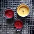 THREE ROMANTIC CANDLES SIT ON A TABLE Royalty Free Stock Photo