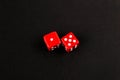 Two red casino dices on the black background Royalty Free Stock Photo