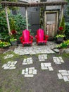 Two red chairs in a chirpy road in the garden