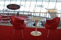 Two red chairs and a white table at the TWA terminal at JFK Airport