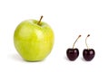 Two cherry berries and one big green apple on white background isolated close up macro