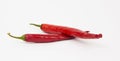 Two red chili peppers lying on a white background. Chilli pepper ready to cook Royalty Free Stock Photo