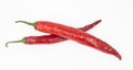 Two red chili peppers lying on a white background. Chilli pepper ready to cook Royalty Free Stock Photo