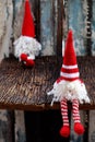 Two red Christmas gnome ornament relax together, cute handmade stuffed toy for decoration Royalty Free Stock Photo