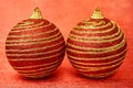 Two Red Christmas toy with gold stripes on a red background close-up. New Year, christmas background. Royalty Free Stock Photo