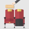 Two red cinema chair in flat design with hand holding blank movie ticket.