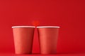 Two red coffee cups with  heart as couple in love on the red background. Valentines day and romantic concept Royalty Free Stock Photo