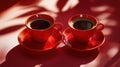 Two Red Coffee Cups on a Red Surface Royalty Free Stock Photo