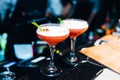 Two Red Colourful cocktails served in nightclub