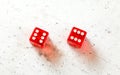 Two red craps dices showing Boxcars or Midnight double number six overhead shot on white board