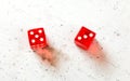 Two red craps dices showing Easy Eight number 5 and 3 overhead shot on white board