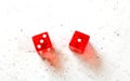 Two red craps dices showing Easy Four number 3 and 1 overhead shot on white board Royalty Free Stock Photo