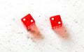 Two red craps dices showing Hard Four / Little Joe double number two overhead shot on white board