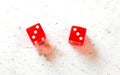 Two red craps dices showing Hard Six double number three overhead shot on white board Royalty Free Stock Photo