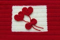 Two red crochet wool hearts and ribbon on crochet background. The concept for 14 February, romantic Valentine day, love affair,