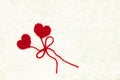 Two red crochet wool hearts and ribbon on white crochet background. The concept for 14 February, romantic Valentine day, love Royalty Free Stock Photo