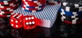 Two red dice, a deck of cards and poker chips, on a black background Royalty Free Stock Photo