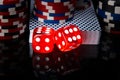 Two red dice, a deck of cards and poker chips, on a black background with mappings Royalty Free Stock Photo