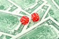 Two red dice lying on the dollar Royalty Free Stock Photo