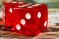 Two red dice on stack of dollar banknotes Royalty Free Stock Photo